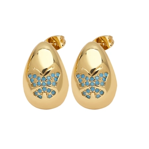 Detail of gold butterfly stud earrings with blue bead accents and polished finish