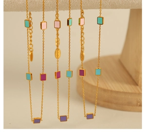 Macro shot of 18K gold plated titanium necklace with colorful enamel rectangular charms
