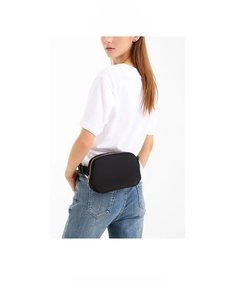 Detailed view of classic black nylon waist bag with gold zipper worn on a model back