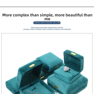 Detailed close-up of dark green velvet jewelry boxes with elegant gold metal clasps