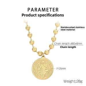 Detailed view of Saint Benedict medal pendant and golden stainless steel ball chain