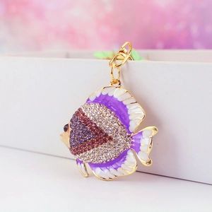 Sparkling tropical fish keychain with purple and white crystals on a gold-plated link
