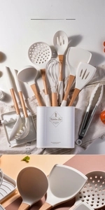 Close-up of silicone kitchen utensils with solid wood handles and storage bucket