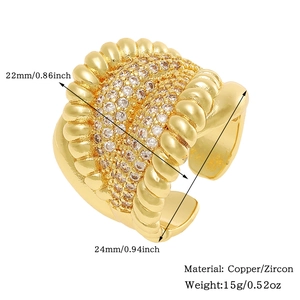 Macro detail of golden ribbed open ring with clear zircon inlay and size dimensions