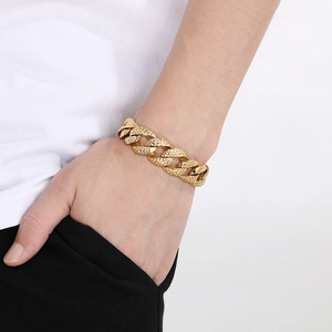 Macro shot of 18mm hammered texture Cuban link bracelet in gold finish on male wrist
