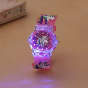 Macro shot showing the glowing blue LED light effect on the pink unicorn kids watch