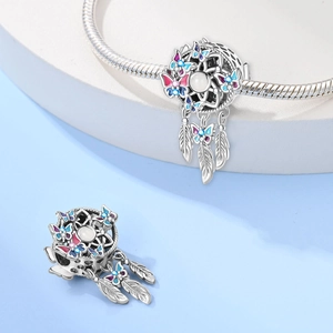 Detail view of silver dreamcatcher charm with enamel butterflies and hanging feathers