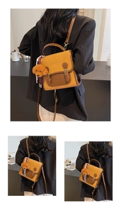 Detailed close-up of retro color-block backpack with teddy bear and silk scarf charm