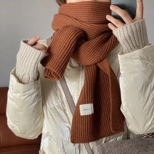Thick brown knitted scarf in a cozy winter style for women, high-quality wool material