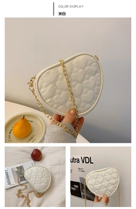 Detailed view of off-white heart-quilted PU leather bag with golden chain strap