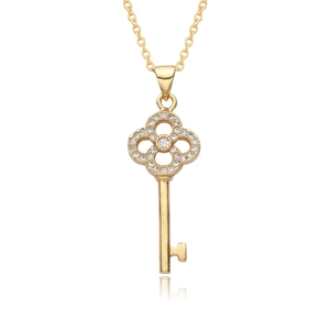 Macro shot of gold-plated heart key necklace with sparkling zircon clover details