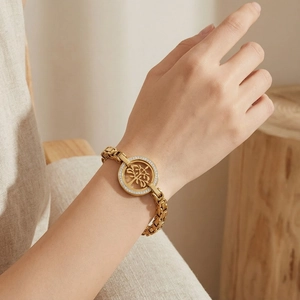 Close-up of a 18K gold-plated Tree of Life bracelet with sparkling zircons on a model