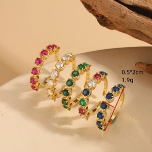 Set of five gold plated open rings with colorful cubic zirconia in a macro view