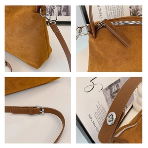 Close-up of silver metal buckle and zipper detail on brown suede shoulder bag