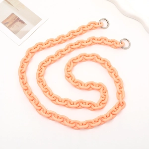 Macro view of peach acrylic crossbody chain strap with silver metal spring buckles