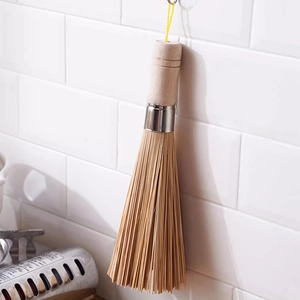 Vintage bamboo kitchen cleaning brush with wooden handle and hanging loop on white tiles
