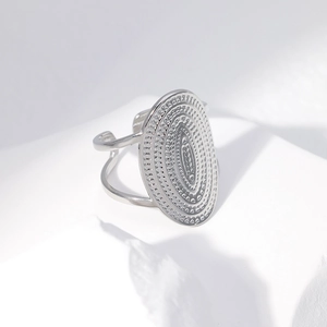 Detailed view of wide minimalist adjustable silver ring with subtle grain texture