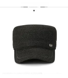 Detail of dark grey wool flat cap featuring a metallic SPORT embossed brim and side badge