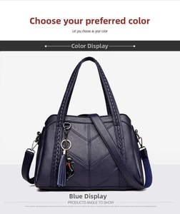 Detail of navy blue leather handbag with litchi texture and V-shaped stitching pattern