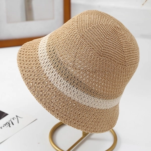 Detail of hollow-out knit pattern on a two-tone beige and tan summer bucket sun hat