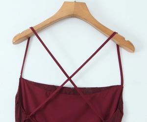 Nahaufnahme des tiefroten Jacquardkleides mit überkreuzten Rückenträgern und Textur