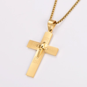 Macro detail of a golden stainless steel cross pendant with textured metal surface