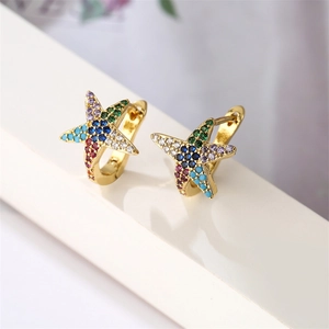 Detailed macro view of gold starfish earrings with vibrant colorful cubic zirconia inlay