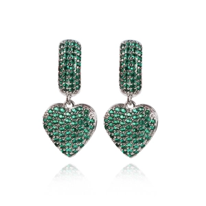 Close-up of silver heart earrings featuring vibrant green pavé-set gemstones and sleek metal