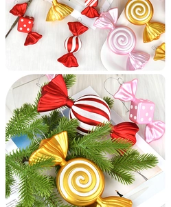 Detailed view of PVC electroplated candy ornaments with striped textures on pine branches