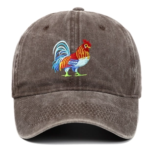 Close-up of rooster embroidery and vintage washed cotton texture on a brown baseball cap