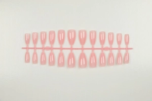 Close-up of 24-piece set of almond-shaped translucent light pink matte press-on nails