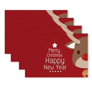 Detailed view of 4-piece red Christmas placemats with reindeer and holiday greetings