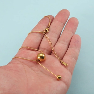 Minimalist stainless steel ball and bar pendant necklace with golden fringe design