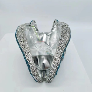 Detailed interior of heart shaped evening clutch bag with silver lining and crystals