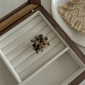 Detailed close-up of tortoise shell pattern claw clip in a velvet jewelry box