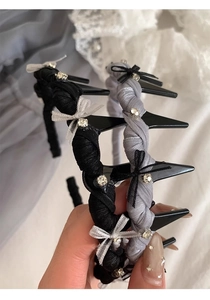 Detail of woven bow headbands in black and grey colors with sparkling rhinestones decoration