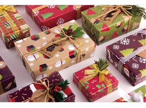 Detail of Christmas gift wrapping paper with ribbons and festive holiday ornaments