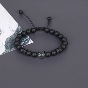 Detailed view of matte black bead bracelet featuring a micro-paved leopard head charm