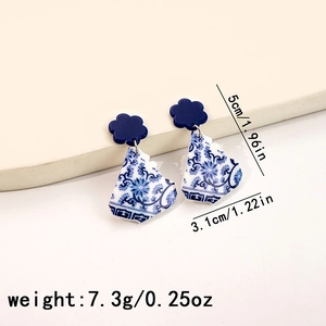 Close-up of blue and white floral acrylic earrings with specific size and weight labels