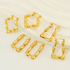 Detailed close-up of golden bamboo texture on U-shaped stainless steel earrings