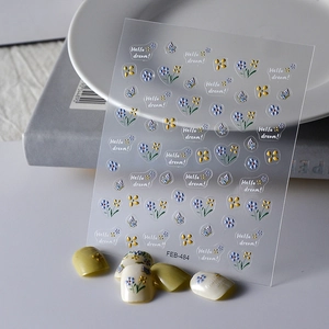 Detail of floral nail art stickers with butterfly patterns and Hello Dream text