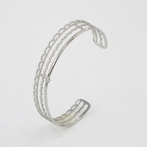 Detailed view of silver C-shaped open bangle with hollow multi-layer skeleton design