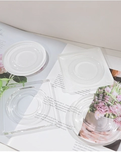 Macro shot of clear acrylic jewelry display trays with textured concentric circle patterns