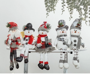 Group of Christmas plush dolls with long legs and knitted textures on a white surface