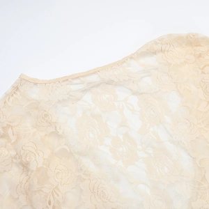 Detailed view of rose lace pattern and delicate neckline on apricot summer dress