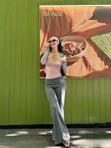 Detailed view of gray knit high-waist wide-leg track pants with matching bolero shrug