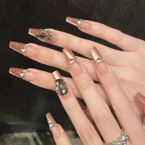 Elegant nude cat-eye press-on nails with luxury rhinestones and long coffin shape