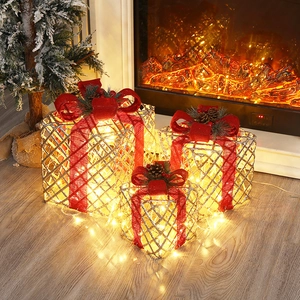 Three-piece glowing Christmas gift boxes with warm LED lights and red bows for decor