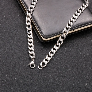 Detail of silver stainless steel Cuban link necklace with secure lobster clasp closure