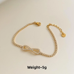 Detailed view of infinity charm bracelet with zircon inlays and stainless steel tag